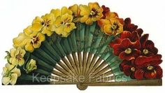 a fan with flowers painted on it sitting in front of a white background and an image of yellow, red, and orange flowers