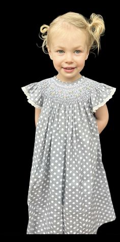 The most beautiful hand-smocked gray dress with small pink roses around the neck. The perfect party or everyday dress. Cute Sleeveless Dress With Smocked Cuffs, Polka Dot Dress With Smocked Bodice And Short Sleeves, Short Sleeve Polka Dot Dress With Smocked Bodice, Polka Dot Short Sleeve Dress With Smocked Bodice, Cute Smock Dress With Flutter Sleeves, Cute Smocked Dress With Flutter Sleeves, Cute Fitted Smocked Dress With Flutter Sleeves, Toddler Smock, Hand Smocked Dress