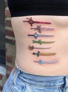 a woman's stomach with many different types of swords on it