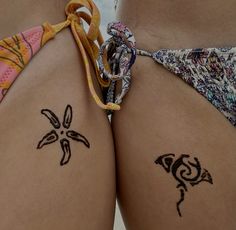 two women with tattoos on their butts