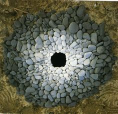 a hole in the ground made out of rocks