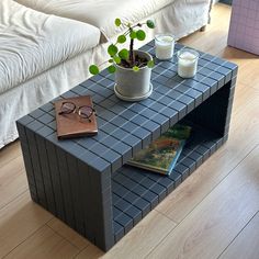 a coffee table with a plant and glasses on it