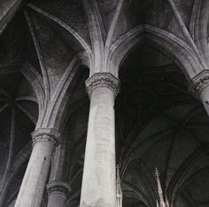 the interior of a cathedral with columns and arches