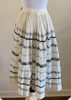 For your consideration Vintage "Made Especially For You by Lil-Beth" patio skirt with silver metallic trim. Feels like cotton gauze. Fits like an XXS / 22" waist but could be reworked - there is room in the pleats to take out.  Pre owned, shows general wear. Faint discoloration in areas and some obvious discoloration on the waistband. The waistband has seam separations on the inside  Shown on size small mannequin - it was too small and had to be pinned for viewing. Please review photos and messa Rodeo Skirt, Vintage White Tiered Skirt, Vintage White Gathered Skirt Bottoms, Vintage Ruffled Cotton Skirt, Vintage White Gathered Skirt, Sparkle Skirt, Square Dancing, Ric Rac, Womens Skirt