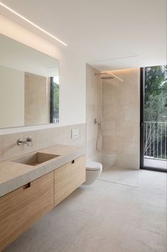 a bathroom with a sink, toilet and shower stall in it's own area