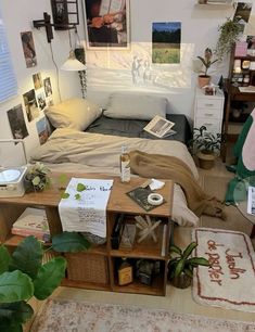 a bed room with a neatly made bed and lots of pictures hanging on the wall