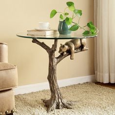 a glass table with a bear on it and a potted plant in the middle