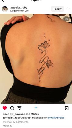 the back of a woman's shoulder with tattoos on her upper and lower back