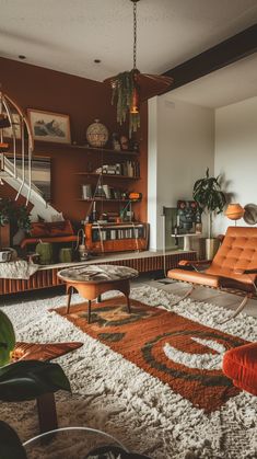 a living room filled with lots of furniture next to a stair case and bookshelf