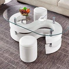 a white coffee table with two stools and a glass top