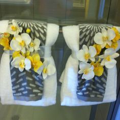 two towels with yellow and white flowers on them