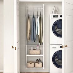 an open closet with clothes hanging on the door and two washers next to it