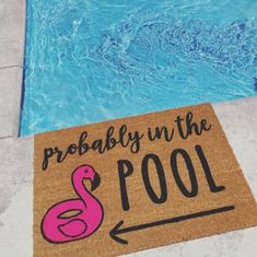 a door mat that says probably in the pool on it next to a swimming pool