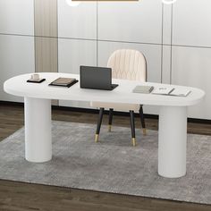 a white table with two laptops on it and a rug in front of it