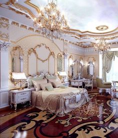 a fancy bedroom with chandelier, bed and mirror on the wall above it