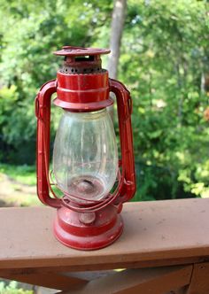 a red lantern sitting on top of a wooden table