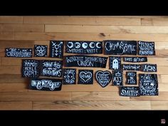 some black and white stickers on a wooden floor next to a wood wall with writing