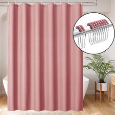 a pink shower curtain with hair pins on it and a potted plant next to it