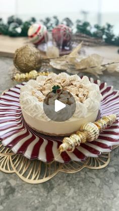 a cake sitting on top of a red and white plate next to other items in the background