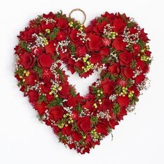 a heart shaped wreath with red roses and baby's breath