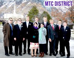 a group of people standing next to each other in front of a snow covered mountain