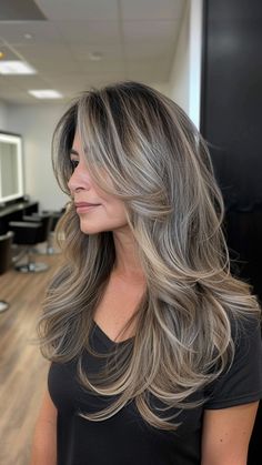 23 Stunning Gray Hairstyles for Older Women Who Radiate Confidence Dark Blonde Grey Blending, Gray Long Hair Older Women, Blonde Hair For Older Women Over 50 Long Hairstyles, Layered Ash Brown Hair, Best Highlights For Greying Hair, Hair Colors For 45 Year Old Women, Ash Blonde Layered Hair, Long Layered Grey Hair, Blended Gray Hair With Highlights