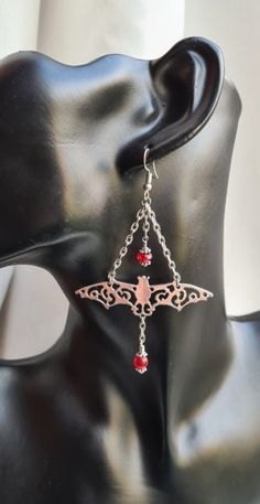 Gorgeous Vampire's Ball Silver-Tone Fancy Bat Dangly Earrings. Beautiful and dangly, these lovely earrings are certainly an ornate pair. With fabulous Silver tone metals and Red glass beads these are so very striking and would be a perfect accessory for a Vampire's Ball.  Use code SPOOKY10 at check out for 10% discount on your purchases. Also see matching necklace available to purchase separately. Earring length is approx 9.5cm long from the top of the ear wire to the bottom of the beads.  Ear W Vampire Earrings, Bat Jewelry, Butterfly Fashion, Gothic Gifts, Unusual Earrings, Unusual Jewelry, Jewellery Uk, Dangly Earrings, Red Crystals