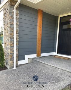 the front door of a house with stone steps and pillars on it's side