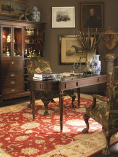 a living room filled with furniture and pictures on the wall