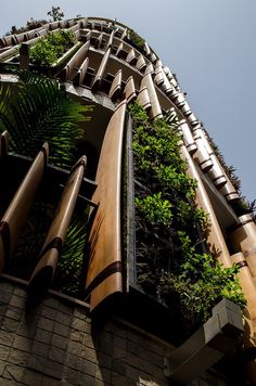 a tall building with plants growing on it's side