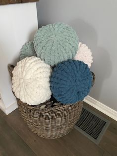 a basket filled with blankets sitting on top of a hard wood floor