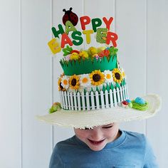 a little boy wearing a hat that says happy easter with sunflowers on it