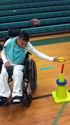 a man in a wheel chair playing with a toy