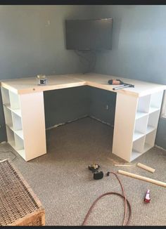 the corner desk is being installed in the room