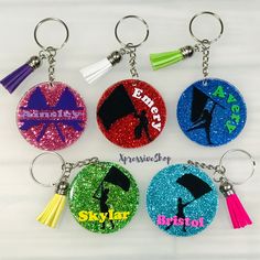 six different colored key chains with graduation caps and tassels on them are shown