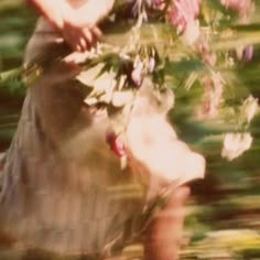 a blurry photo of a woman holding flowers