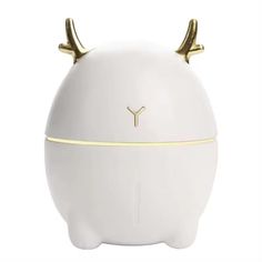 a white vase with gold horns on the top and bottom, sitting in front of a white background