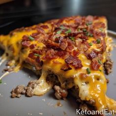 a slice of pizza on a plate with cheese and meat toppings, ready to be eaten