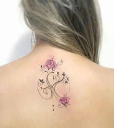 the back of a woman's neck with pink roses and vines on her left shoulder