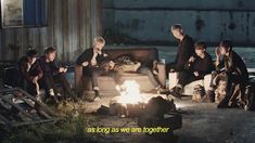 a group of people sitting around a fire pit