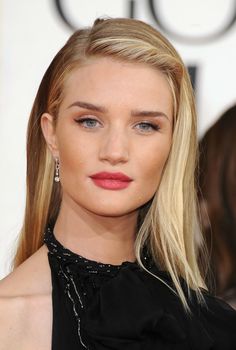 a woman with blonde hair and blue eyes wearing a black dress at the golden globe awards