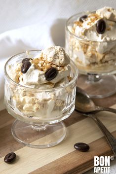 two desserts in glass dishes on a wooden table