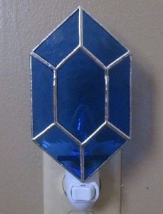 a blue glass light switch cover on a wall