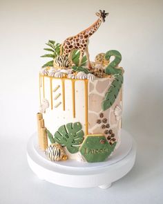 a giraffe is standing on top of a cake