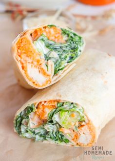 two wraps filled with vegetables on top of a table