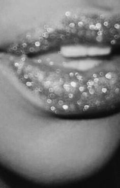 black and white photograph of woman's lips with glitter on them