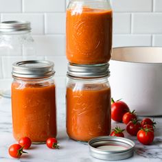 three jars filled with food sitting on top of a table