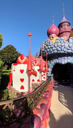 there are many colorful buildings on the side of this road that is decorated with flowers and hearts