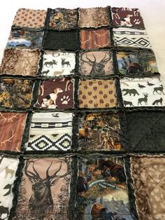 a patchwork quilt with animals and deers on it's sides, all in different colors