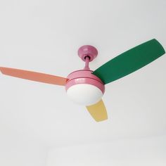 a pink and green ceiling fan in a white room